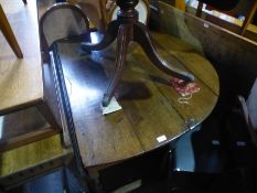An antique oak oval oak gateleg table on turned supports