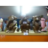 A set of three wooden carved seated monkeys