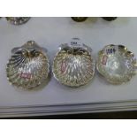 A decorative high quality pair of silver bon bon dishes of a scallop shell on three ball feet, hallm