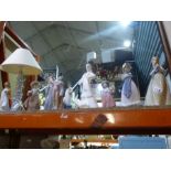 A quantity of Nao figures including a lamp, a Lladro Matador and Doulton lady with chickens