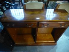 A pair of reproduction yew wood open bookcases having two drawers to each