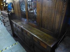 A reproduction oak sideboard having two central gl
