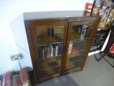 An Oak leaded glass bookcase by Jentique