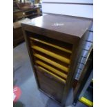 An oak filing cabinet having tambour front