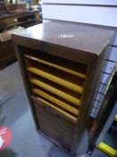 An oak filing cabinet having tambour front
