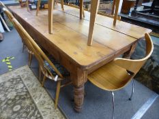 An antique pine kitchen table having two drawers on turned legs, 219 cms