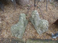 A pair of reconstituted stone pouncing lions, with ram's heads, on oblong base, 59 cms