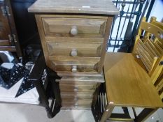 A pair of pine three drawer bedside chests