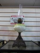Vintage green glass oil lamp together with a large red glass vase