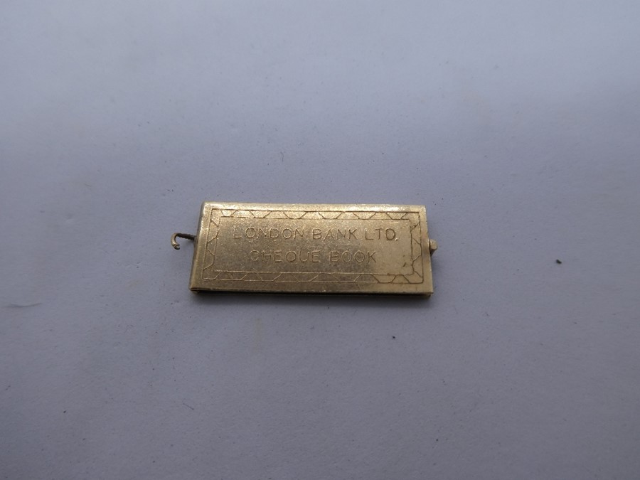 9ct yellow gold pendant marked 375, in the form of a cheque book, 'London Bank Ltd', enclosed a mini - Image 4 of 5