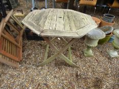 A teak octagonal garden table and three