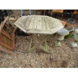 A teak octagonal garden table and three