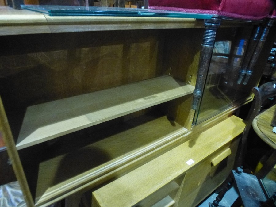 an oak bookcase having sliding glass doors, and a similar small sideboard