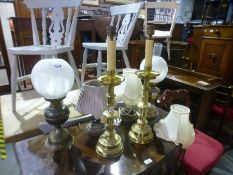 Two oil lamps with shades, two brass candlestick lamps, and two other lamps with shades.