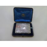A very high quality silver card case with enclosed pencil and ivory writing panel. With ornate, foli