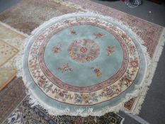 A modern Chinese circular rug, cream bordered, 203cm