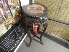 A Chinese carved hardwood jardiniere stand with pierced decoration and rouge marble top, 92 cms high