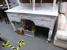 A Victorian painted pine desk having five drawers on turned legs.