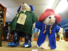 A Paddington Bear teddy having blue boots and a smaller example