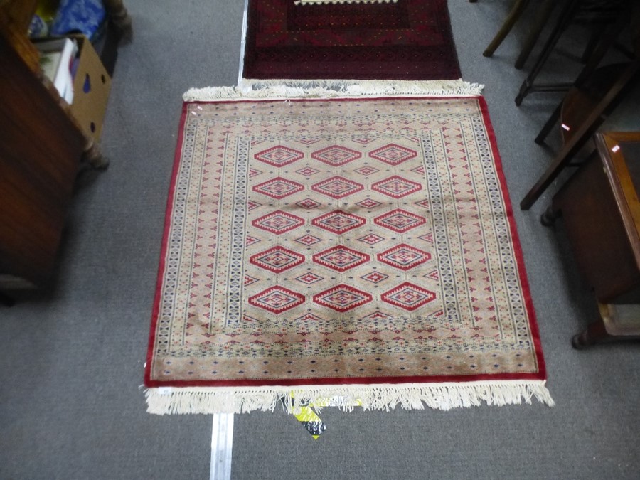A modern square Bokhara rug having fifteen central diamond pods 115cm x 128cm