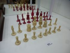 19th Century ivory chess set, some damaged and a replacement red queen