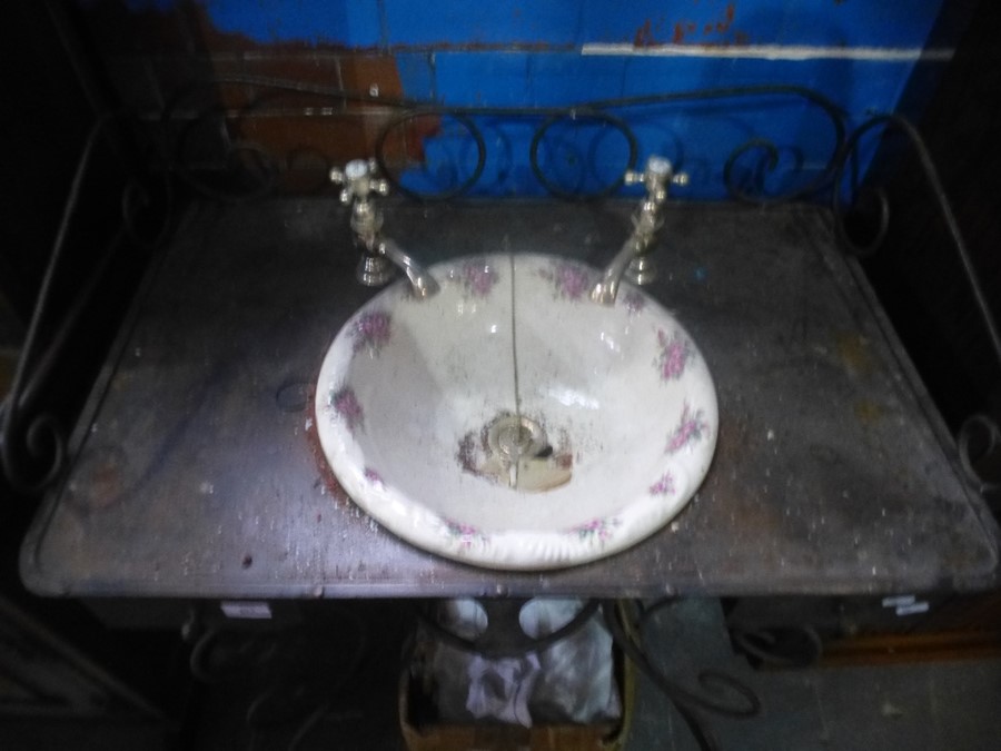 An ornate French style iron washstand having two drawers