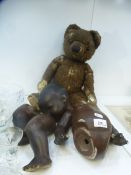 An Armand Marseille 351/8K black bisque head doll and an old teddy bear