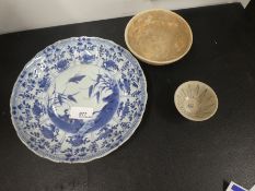 A Chinese blue and white dish and two other Chinese bowls.