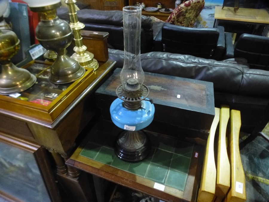 An antique desk slope, a victorian oil lamp and a box of sundry