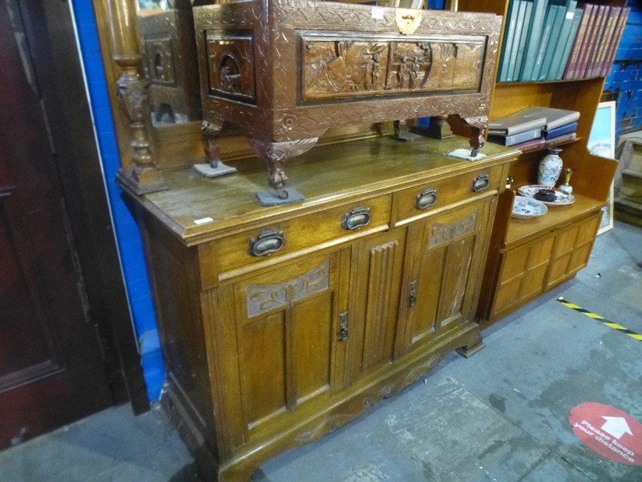 An early 20th century oak mirror back sideboard having two drawers with cupboard below