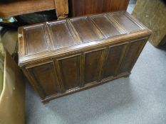 An oak effect coffer and a retro chair on metal legs.