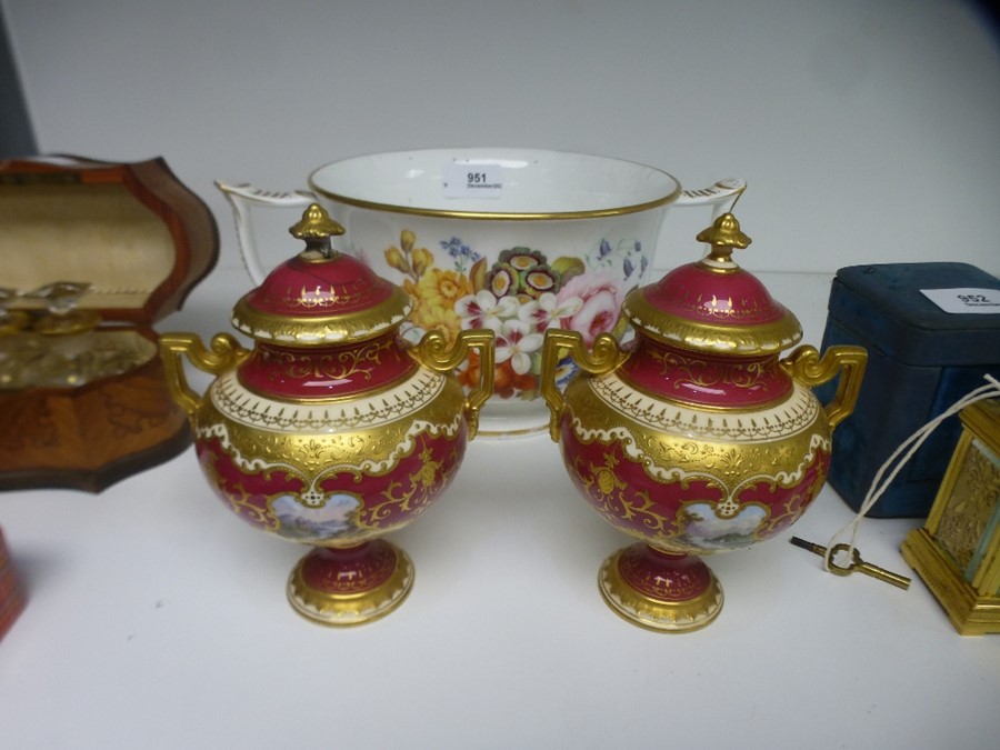 A pair of Coalport small urns and covers having landscape panels and all over gilt decoration. Also