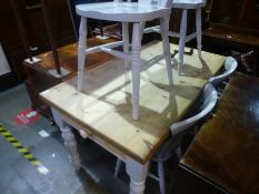 A pine oblong kitchen table having one drawer and a set of four painted kitchen chairs