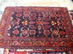 A Hamadan style rug, the central panel having geometric designs 218 x141cms