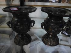 A pair of small oriental bronze vases having flared rims