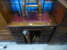 A small reproduction pedestal desk and a stool