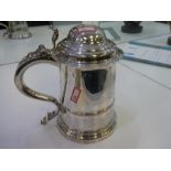 A large George 11 silver cylindrical tankard, hinged domed cover with scroll thumpiece and heavy han