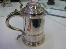 A large George 11 silver cylindrical tankard, hinged domed cover with scroll thumpiece and heavy han