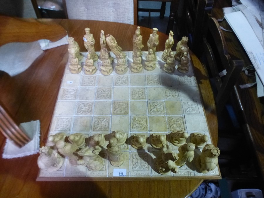 A plaster chess set having oriental style figures
