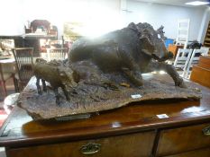 A wood carving of lying Boar and young, 78 cms