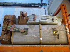 A vintage travelling trunk and three suitcases