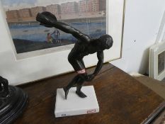 A vintage metal figure of a Discus thrower on a recent marble base, height approx 30 cms