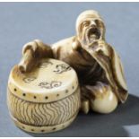 Netsuke of a seated man with drum, 19th c.