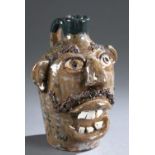 Folk pottery face jug.