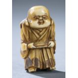 Netsuke of a man holding a book, 19th c.