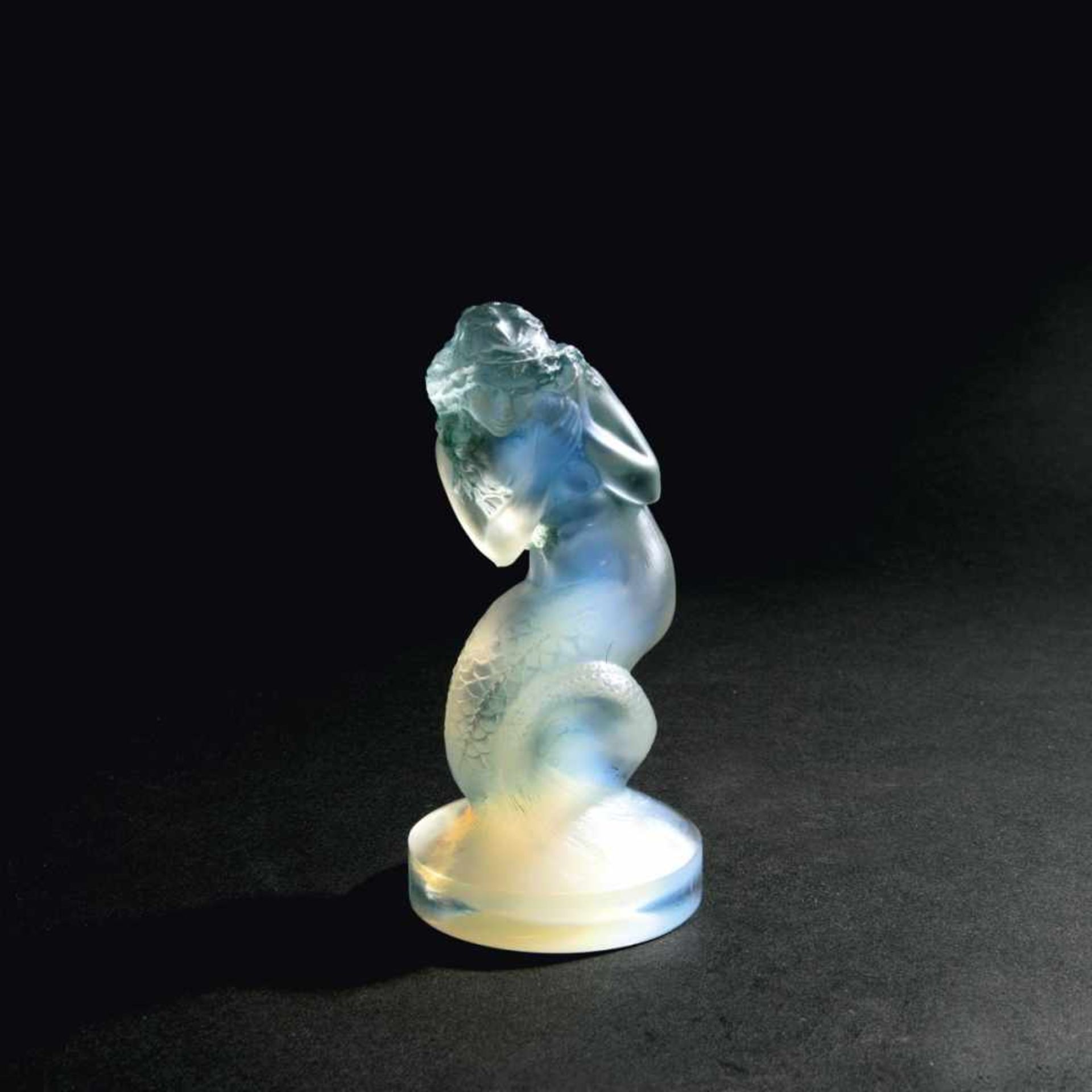 René Lalique, 'Naiade' figurine, 1920'Naiade' figurine, 1920H. 13.5 cm. Clear, moulded glass, blue