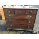 A nineteenth century mahogany chest with three short drawers above three long graduated drawers, all