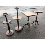 Two smokers stands on turned columns; and two tripod occasional tables - one scalloped with tray