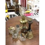 A brass Aladdin oil lamp with glass chimney; six glass oil lamps with brass mounts; and a small