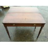 A nineteenth century turn-over-top mahogany tea table, the rectangular rounded leaves with reeded